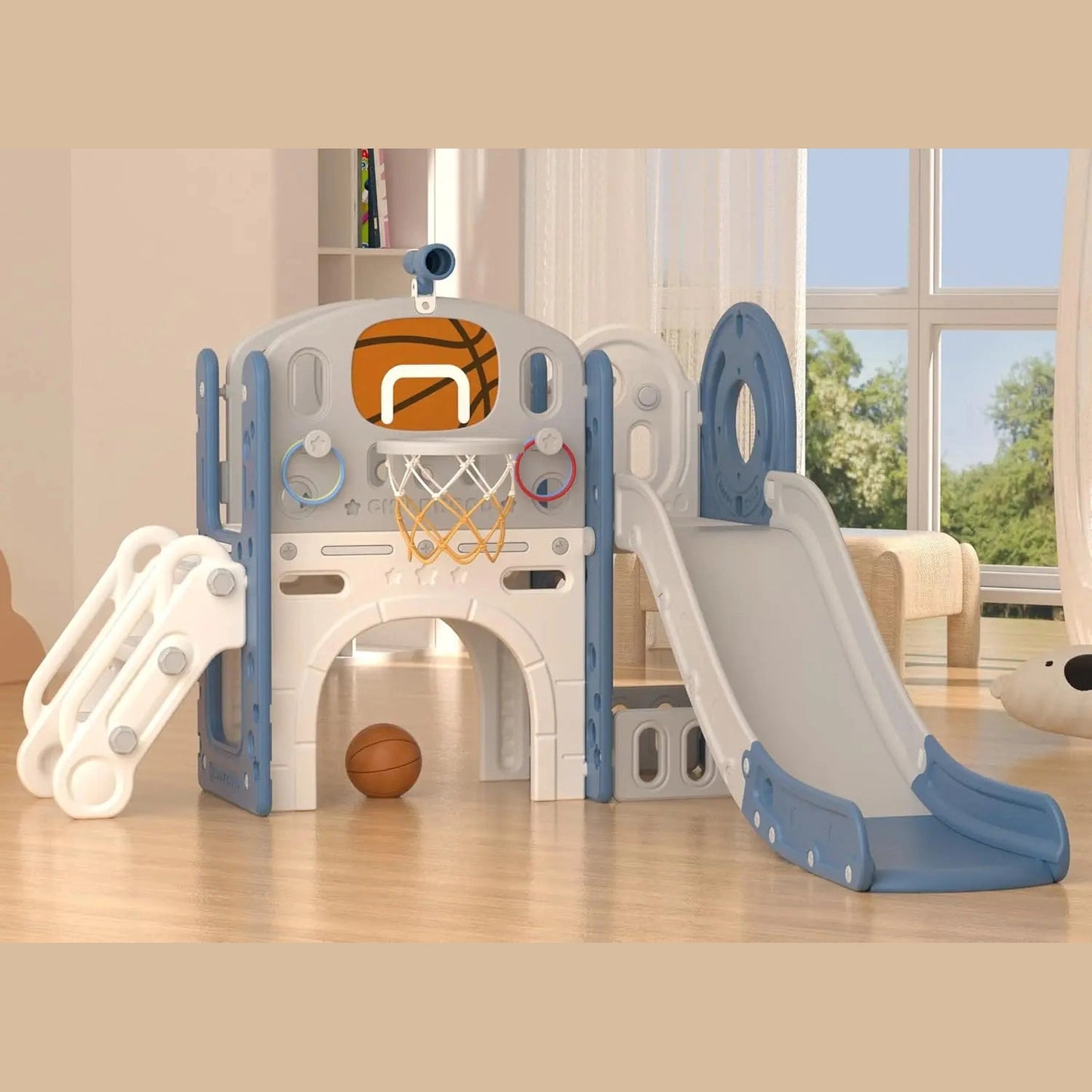 The 8 In 1 Toddler Slide Set With Basketball Hoop For Kids in Blue Gley includes a slide, climbing steps, mini basketball hoop, and tunnel. A basketball sits on the wooden floor of a bright room with large windows and beige curtains.