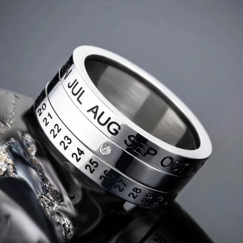 The Stainless Steel Anxiety Ring for Men and Women features rotating bands with months and dates, letting you customize a specific date. A gem marks your chosen day, making this anti-stress fidget spinner ring ideal as a unique engagement or punk jewelry piece.