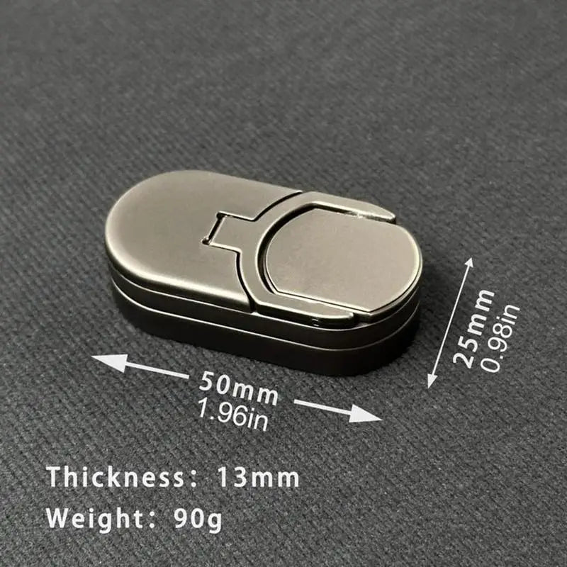 The Fidget Slider Magnetic Metal Spinner Toy sits on a dark surface, ideal for home, travel, or school. Its small oval shape measures 50mm long, 25mm wide, 13mm thick, and weighs 90g—a portable sensory spinner for adults.