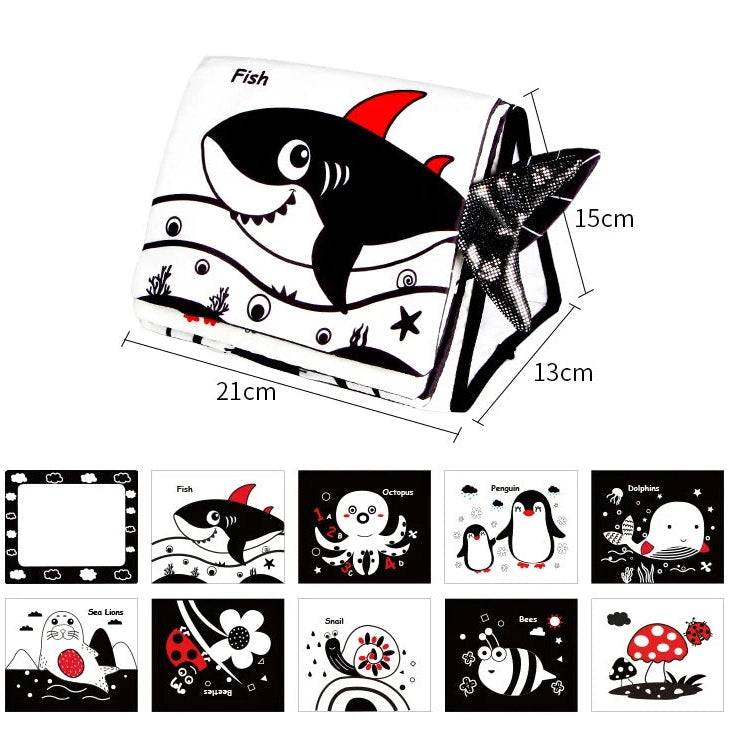 The Crinkle Cloth Book is a soft, foldable toy measuring 21x15x13 cm, featuring black-and-white marine illustrations like sharks and penguins. It promotes visual stimulation and sensory exploration with playful sea-themed patterns and red accents for newborns aged 0-3 months.
