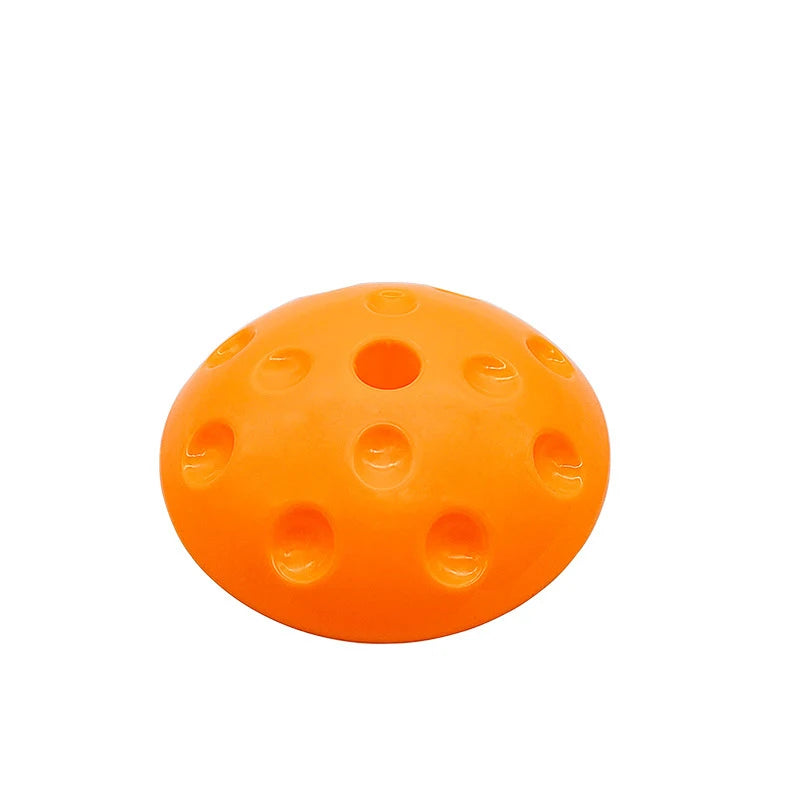 A Montessori-Inspired orange plastic training cone, dome-shaped with circular indents, sits on a white background, ideal for enhancing kids balance and developing motor and social skills through sensory play.