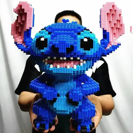 A person holding the Large Stitch Building Block Assembly Toy—a 30cm 3D puzzle and DIY childrens toy built with blue and pink bricks to form Stitch’s face, ears, and body; perfect as a birthday gift or desktop decoration.