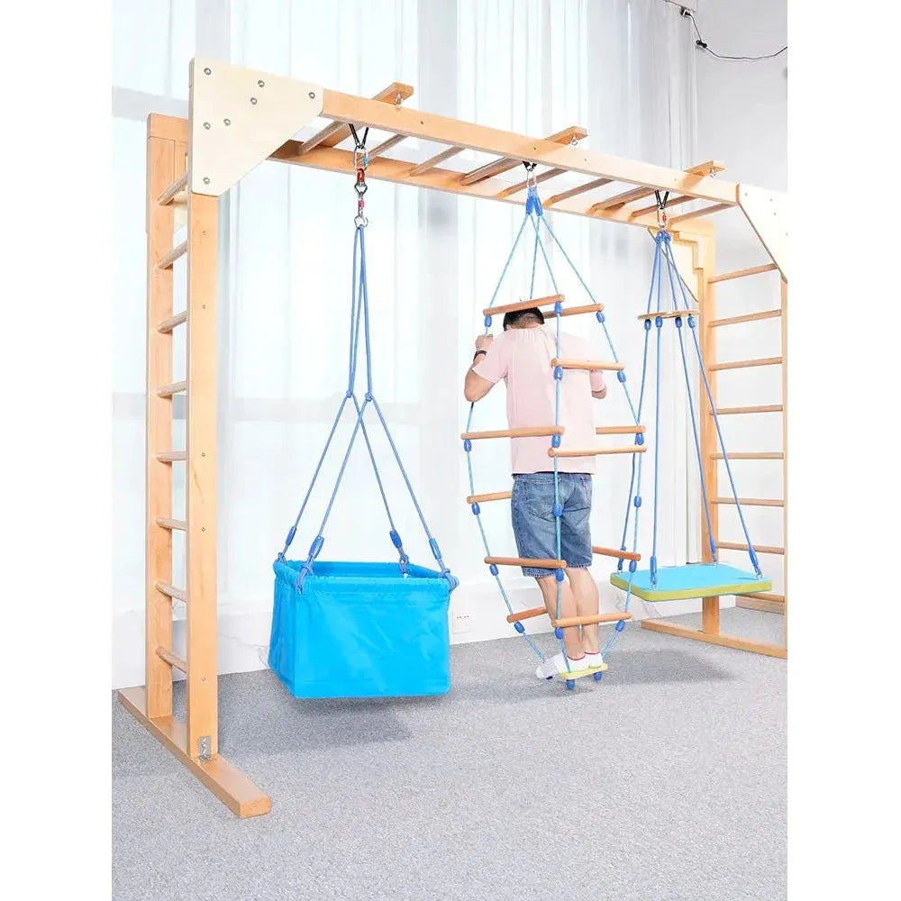 A child explores the Indoor Sensory Fitness Ladder for Kids, with its blue box swing, rope climbing ladder for sensory integration, and a blue-green platform swing. The inviting setup rests against a white curtain on gray carpet.