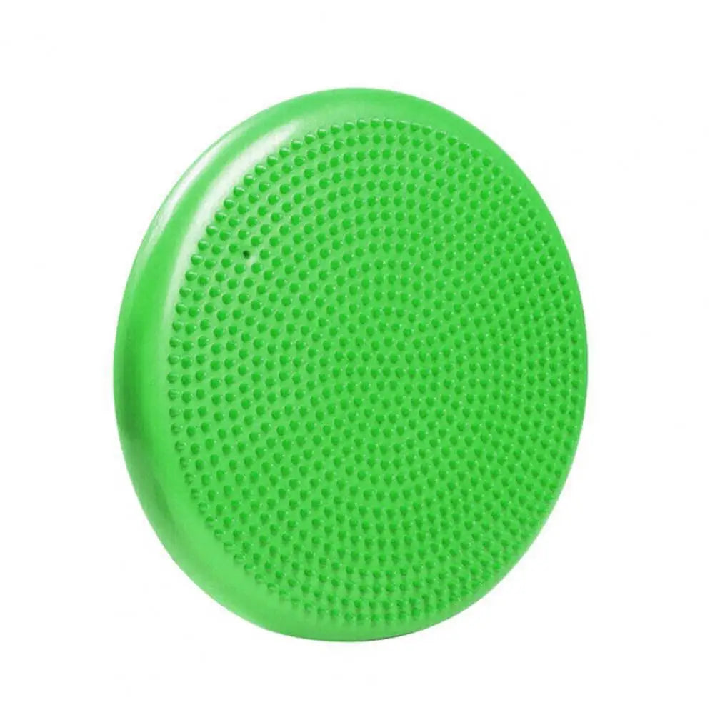 A green balance disc from the Non-Slip Balance Training Mat Set with Air Cushion Disc, featuring a textured spiky surface, is displayed on a white background—ideal for enhancing yoga sessions and boosting core strength.