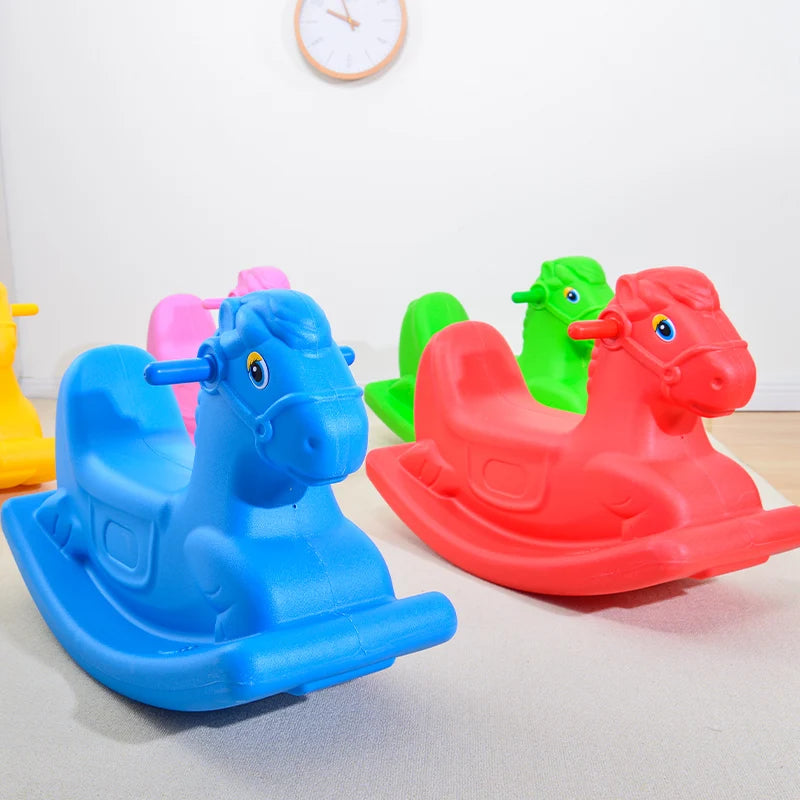Monochrome wooden rocking horses for toddlers are arranged on a light-colored floor, ideal as a gift. A wall clock is visible in the background.