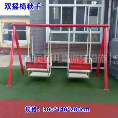 A red and white Outdoor Steel Climbing Frame Swing for Childrens Sensory Integration Training, part of exciting outdoor play equipment, sits on green turf in front of a windowed building. Chinese text and 300*140*200cm dimensions are seen in the image.