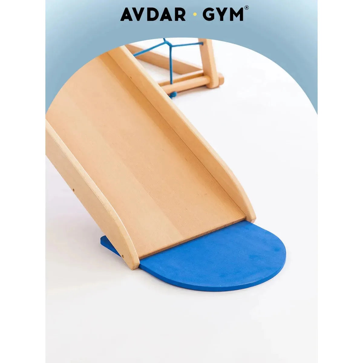 A wooden slide with a blue mat, ideal for indoor fun, set against a white backdrop. Above is a blue semi-circle featuring AVDAR GYM in black text. Purchase the Indoor Adventure Climbing Frame for Kids with Slide and Swing - perfect for family fun playgrounds!.
