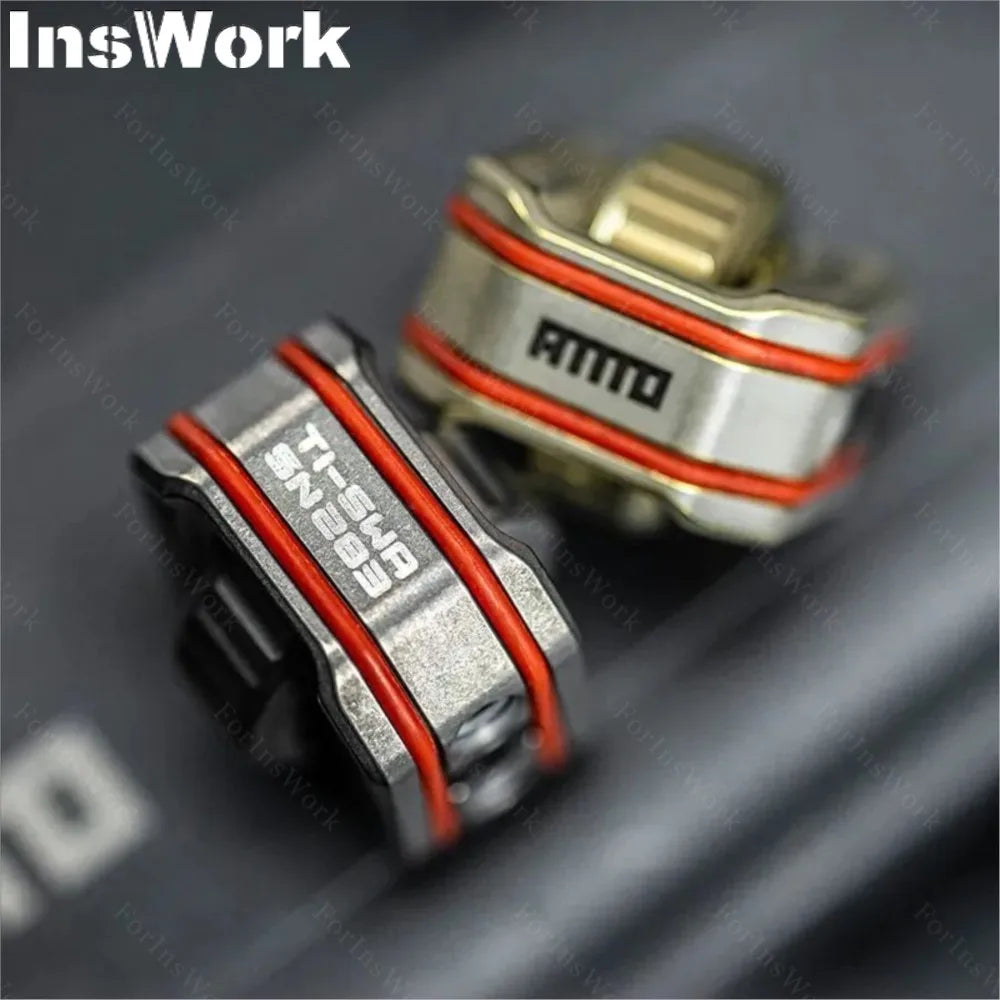 Close-up of two metallic Ammo Cracker Unzip Roller Fidget Toy Stress Relief Slider EDC Tools with orange stripes and engraved InsWork and AMMO text, designed for stress relief on a dark surface.