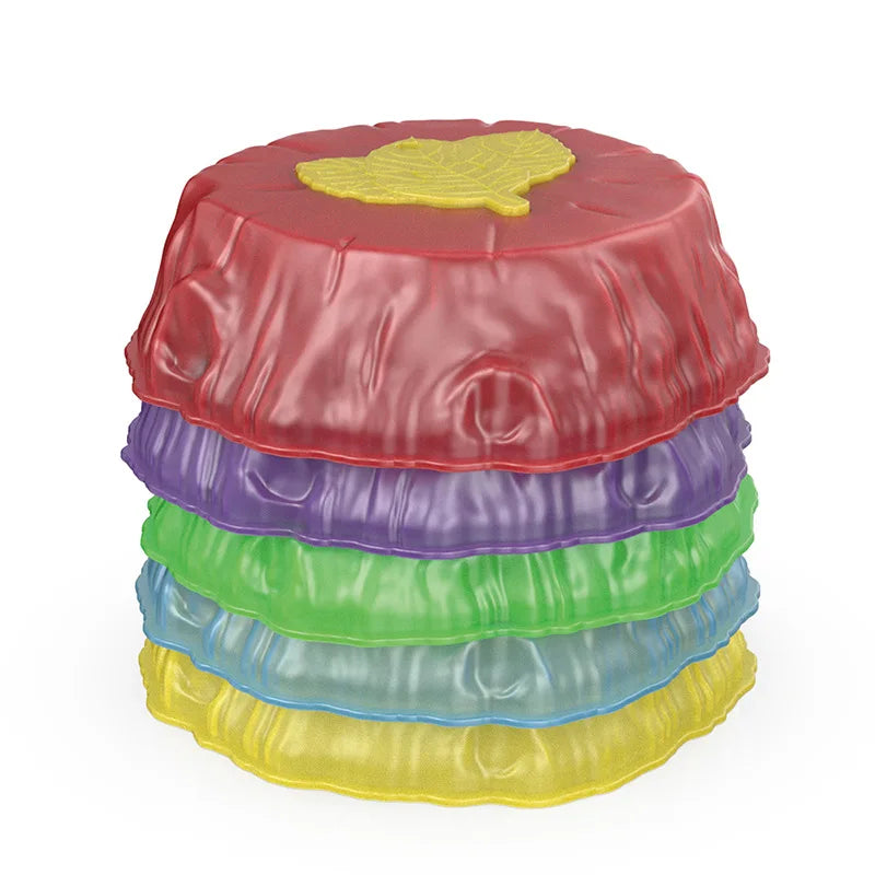 A set of five colorful circular stones—red, purple, green, blue, and yellow—with leaf patterns and textured sides resembling wrapped candies. These vibrant pieces are Rainbow Luminous Balance Stones for Kids, designed as outdoor sensory play training toys and reminiscent of whimsical stepping stones.
