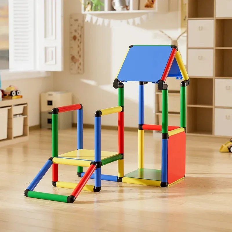 The Indoor Climbing Frame Set for Kids includes vibrant red, blue, green, and yellow interlocking plastic tubes and panels. It resembles a small house with a fun open interior and surrounding play area. The room boasts toy storage and bright natural lighting.