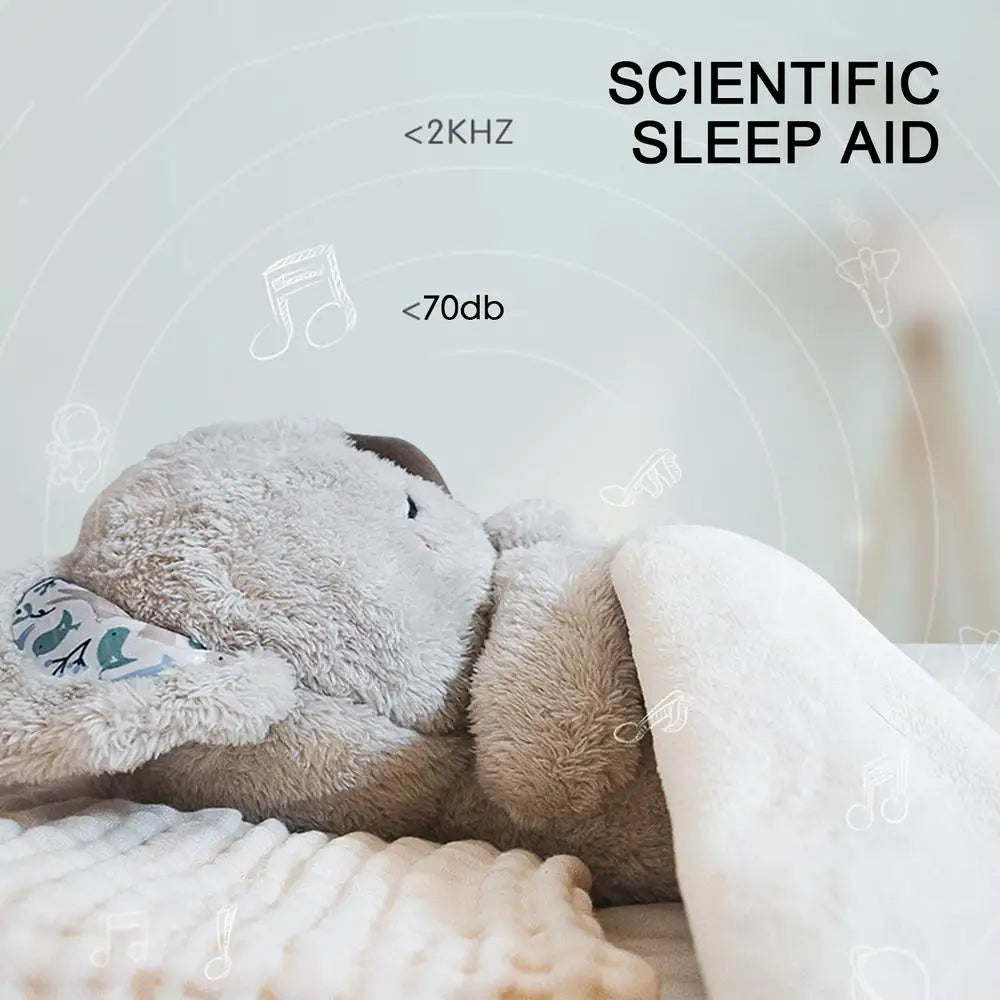 A Koala Night Light Plush Toy rests on a bed, partially covered by a blanket, surrounded by musical note icons that promise soothing melodies. Text reads SCIENTIFIC SLEEP AID with sound specifications <2KHZ and <70db.