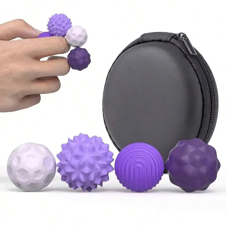 A hand holds a silicone magnetic ball from the 4Pcs PURPLE set for adults, with three more balls placed near a round black zippered carrying case.