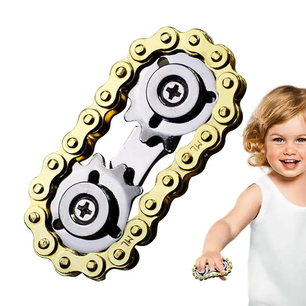 A child grins while holding a Sprockets Flywheel Fingertip Gyro, a metal EDC spinner with gold and silver bike chain design, perfect for stress relief and fun—ideal for dropshipping.