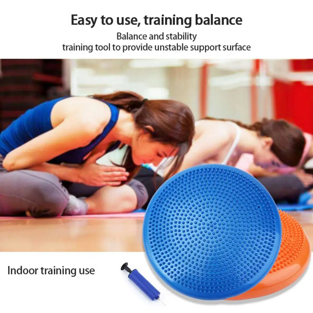 Two people practicing yoga indoors use a Non-Slip Balance Training Mat Set with air cushion discs to boost core strength and stability. The scene includes a blue and an orange disc, along with a small pump.