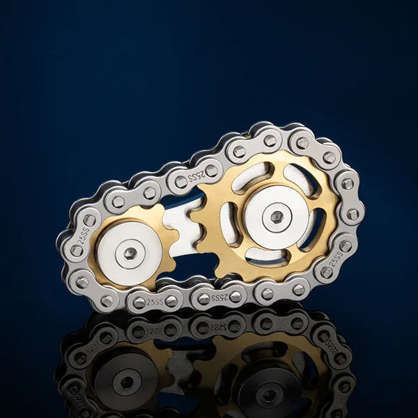The Bike Chain Metal Fidget Spinner with Magnetic Slider is a 9 gear linkage toy for stress relief, featuring interlocking gears that join two cogs elegantly. Set on a dark blue backdrop, its shimmer reflects below, making it an ideal fun gift for adults.