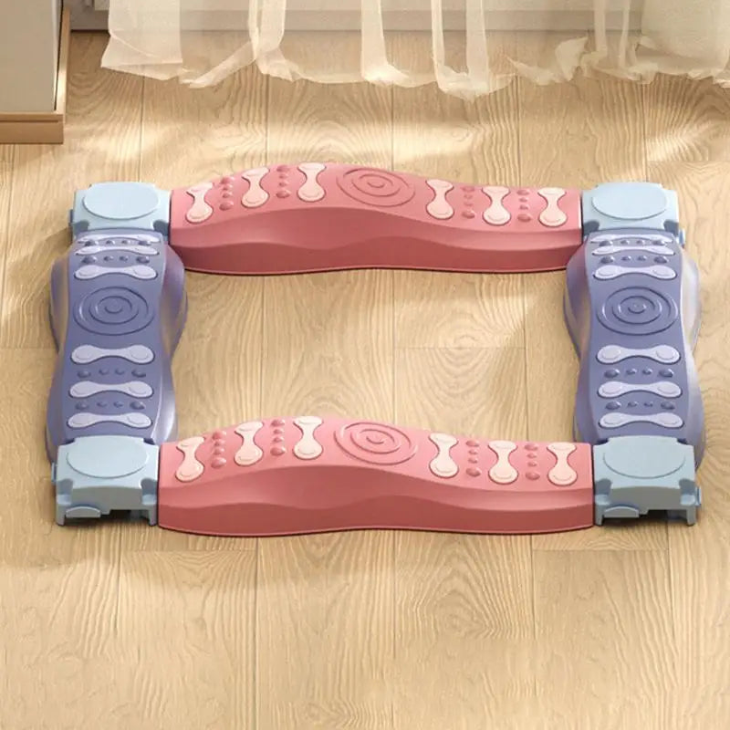 A pink and purple rectangular foldable gate with swirls and bone shapes is on a hardwood floor. This playful pet gate also serves as the Sensory Balance Beam Training Board for Kids, designed to engage pets while promoting coordination with its textured grip.