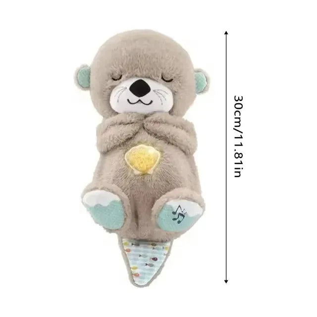 The Musical Breathing Otter Plush Toy is a 30 cm stuffed otter with closed eyes, holding a glowing yellow heart. Featuring light blue paw accents, it plays a lullaby, making it perfect for newborn comfort and sensory play.