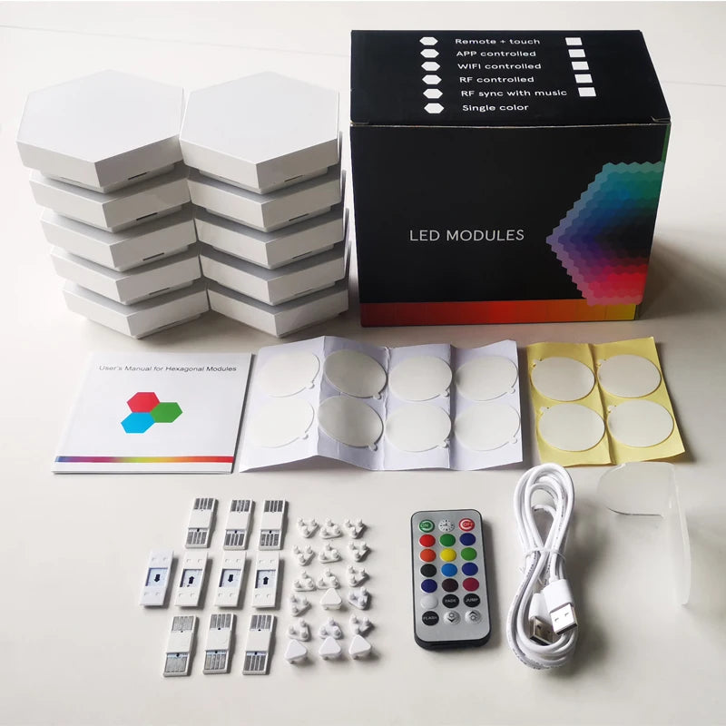 A set of Modular Hexagonal LED Wall Panels with a black box labeled LED MODULES. Theyre color-changing, perfect as a DIY night light, and include a remote control, USB cable, user manuals, adhesive pads, and connectors on display.