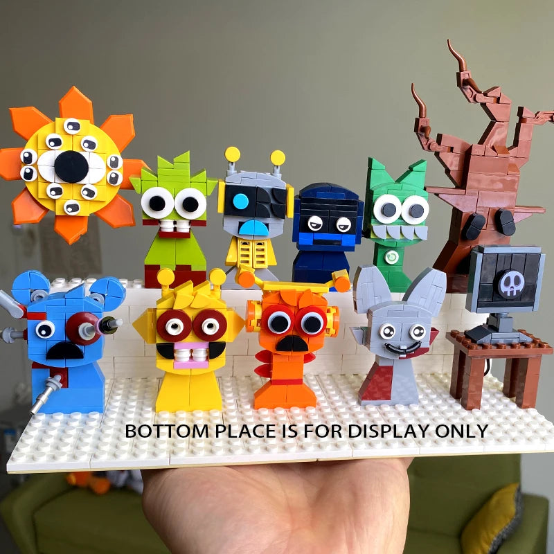 Nine quirky PURPLE LEGO creatures from the New Moc Incredibox Sprunki Building Blocks Set are shown on a white platform held by a hand, with a pixelated tree behind and BOTTOM PLACE IS FOR DISPLAY ONLY text. Perfect birthday or Christmas gift!.