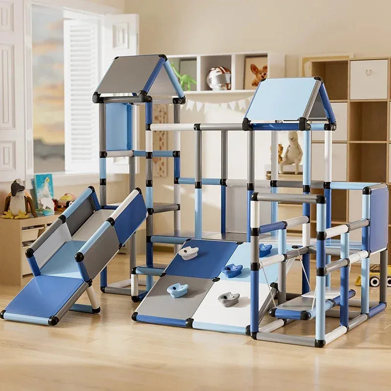 The Indoor Climbing Frame Set for Kids features a small climbing wall and baby slide with blue, gray, and white panels, ideal for sensory integration training. Its set in a well-lit room with shelves and toys in the background.