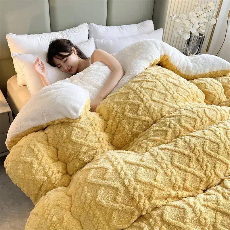 A woman sleeps peacefully in a bed with fluffy white pillows and a thick yellow blanket. The cozy setting, featuring white flowers in a vase, is enhanced by the Luxurious Artificial Cashmere Weighted Blanket for Ultimate Winter Comfort, ensuring her restful slumber.