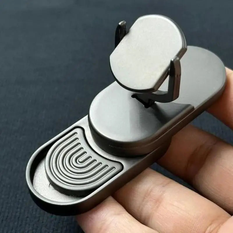 A hand holds the Fidget Slider Magnetic Metal Spinner Toy, a small metallic oval-shaped sensory spinner with a sliding mechanism and raised rubber pattern, ideal for adults’ privacy and stress relief at home, during travel, or at school.