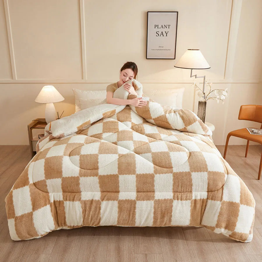 A person sits on a bed wrapped in the KDJEIKZ Ultra Cozy Winter Weighted Blanket, featuring a checkered beige and white pattern. The room has two lamps, a plant, wall art, and a wooden chair. Soft lighting enhances the milk velvet texture for an irresistibly cozy atmosphere.