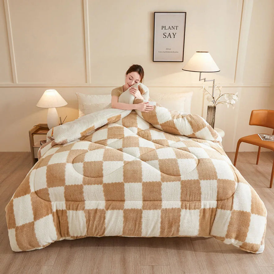 A person sits on a bed wrapped in the KDJEIKZ Ultra Cozy Winter Weighted Blanket, featuring a checkered beige and white pattern. The room has two lamps, a plant, wall art, and a wooden chair. Soft lighting enhances the milk velvet texture for an irresistibly cozy atmosphere.