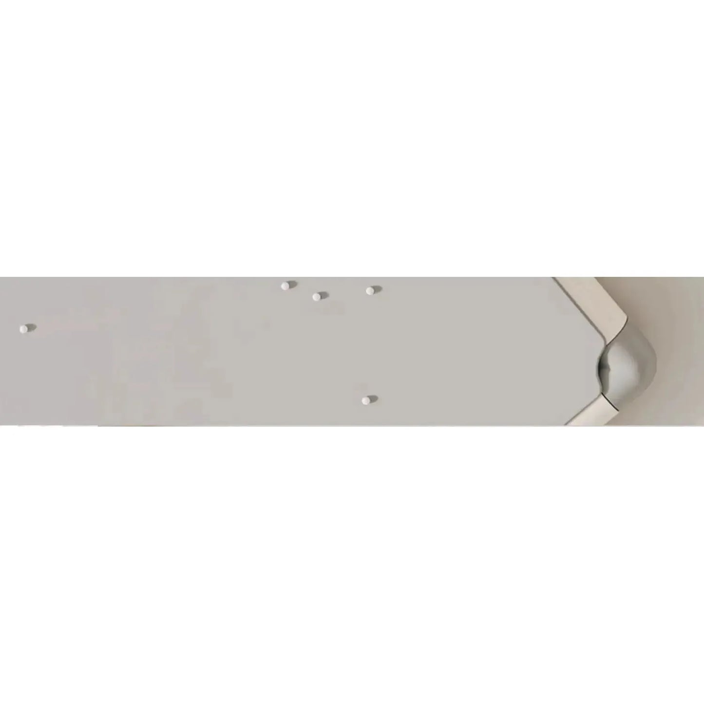 Close-up of a skateboard decks underside mimicking the sleek, minimal surfaces of the Indoor Climbing Adventure Set for Kids. Focus is on grip tape and truck mounting holes with a glimpse of the decks edge on the right side.