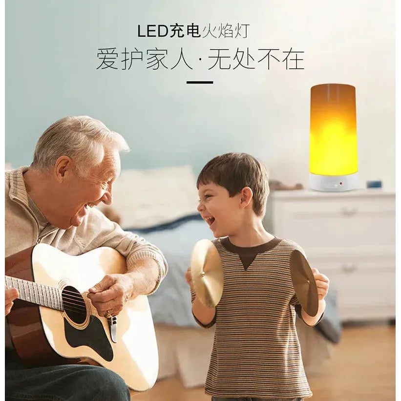 A joyful senior plays an acoustic guitar as a smiling young boy holds cymbals. A Simulated Flame LED Night Light adds warmth to the cozy, blue-walled room with a bed. Chinese text is displayed at the top.