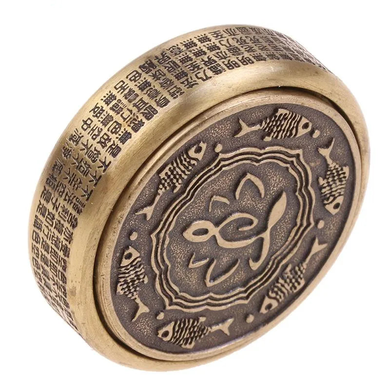 A round metal Zen Buddha Fidget Spinner featuring engraved designs, inspired by Chinese motifs, made from brass for stress relief and focus; perfect as an adult EDC fidget toy from Mainland China.