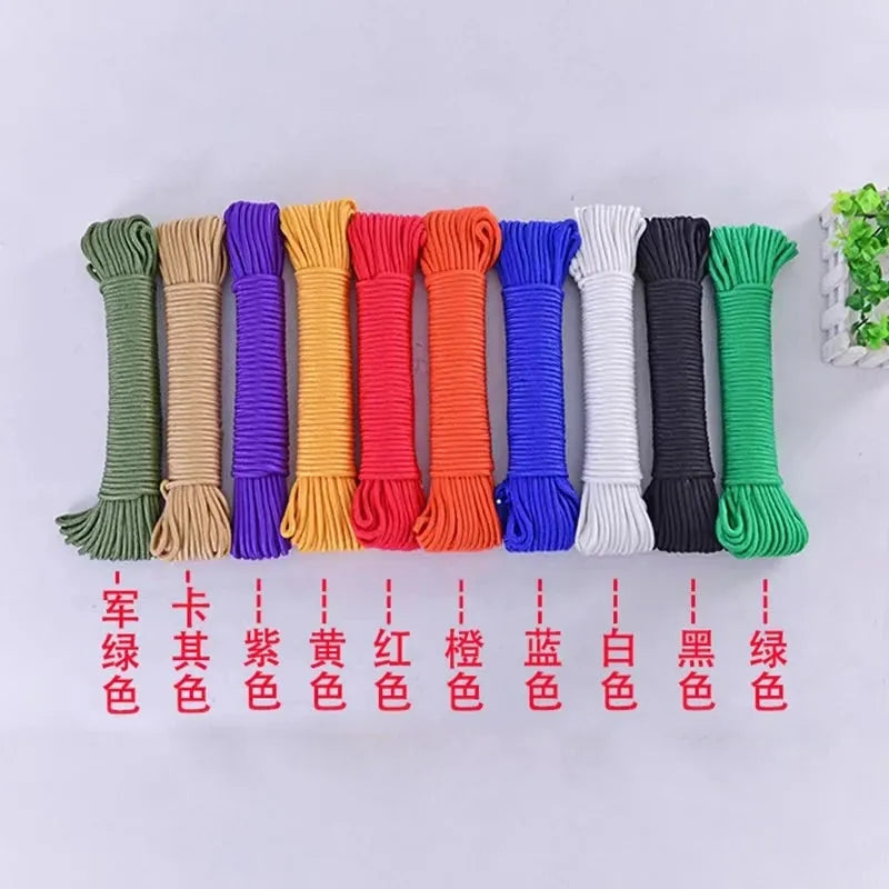 Ten bundles of beige, purple, yellow, red, orange, blue, white, black, and green cord are arranged horizontally on a wooden base. Each has a red label and they enhance an Indoor Wooden Climbing Frame for Kids with Slide and Swing - Sensory Play Set.