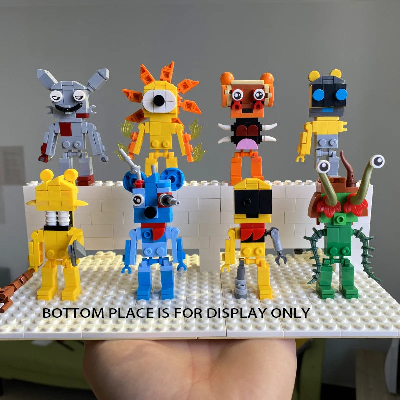 Eight green animal and monster figures from the New Moc Incredibox Sprunki Building Blocks Set are displayed on a handheld platform, with an elevated back row. Front row label: BOTTOM PLACE IS FOR DISPLAY ONLY. Great for horror anime music game fans!.