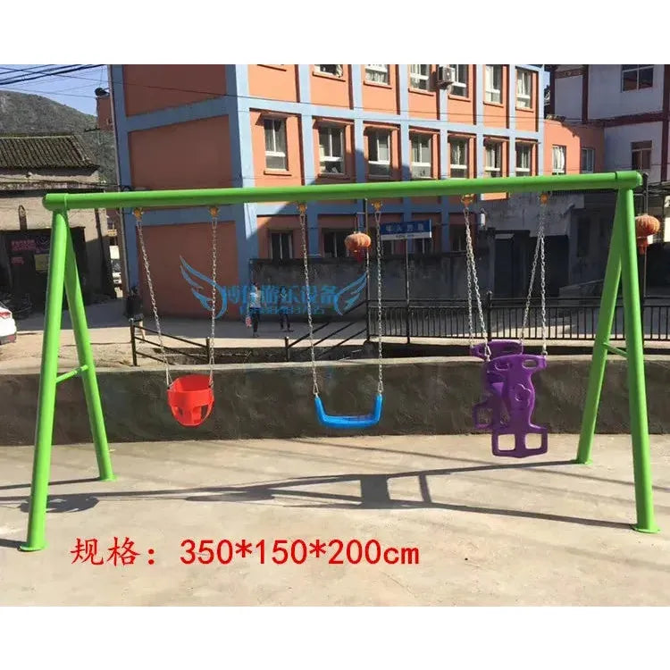 A violet swing set with three childrens swings is outdoors, featuring a red infant swing, a blue U-shaped swing, and a purple animal-shaped swing. In the background are mountains and a building. Dimensions are provided at the bottom.