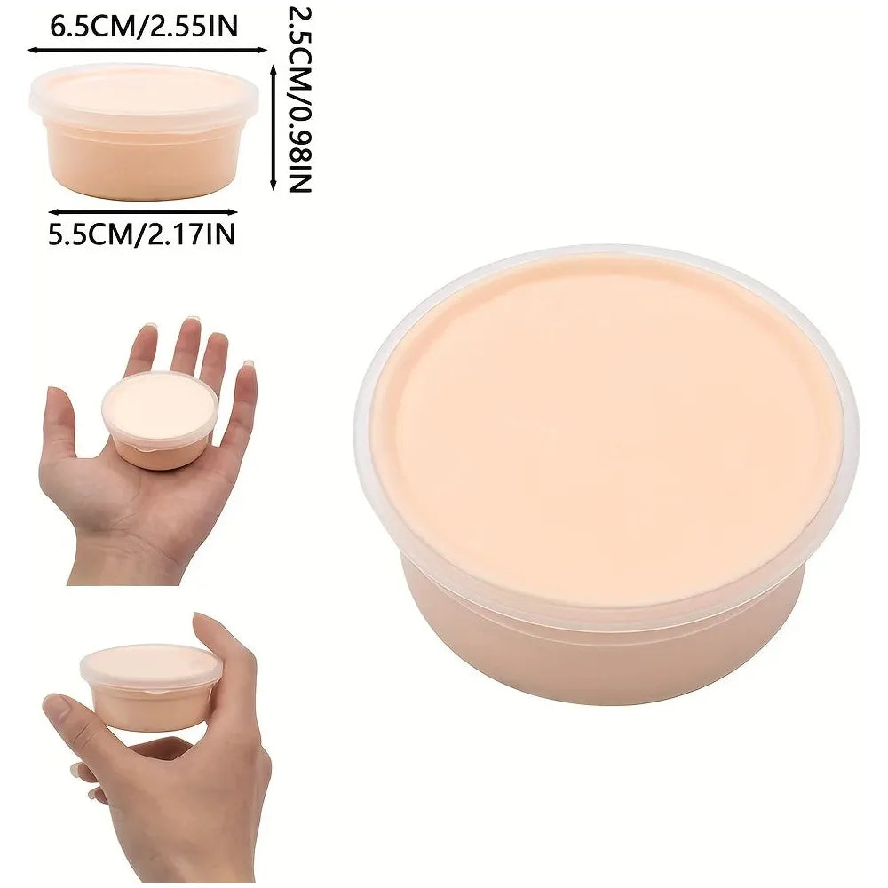 The Sensory 60ml Butter Slime Polymer Putty is shown in a small, round flesh-colored container with a clear lid, ideal for holding slime. It measures 6.5 cm in diameter and 2.5 cm in height. The non-sticky formula allows for easy handling as its held for size reference.