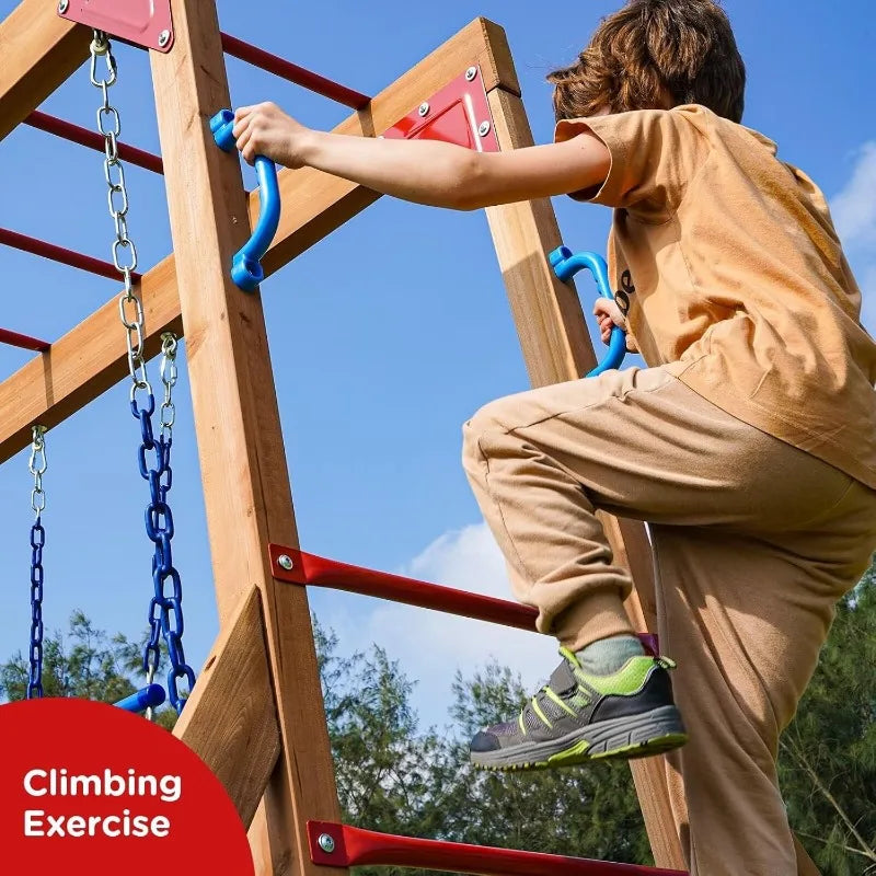 A child in a tan outfit and gray sneakers climbs the Wood Swing Sets for Backyard with Monkey Bar Playset, featuring blue handles and red bars. Climbing Exercise text appears, with trees and blue sky visible in the background.