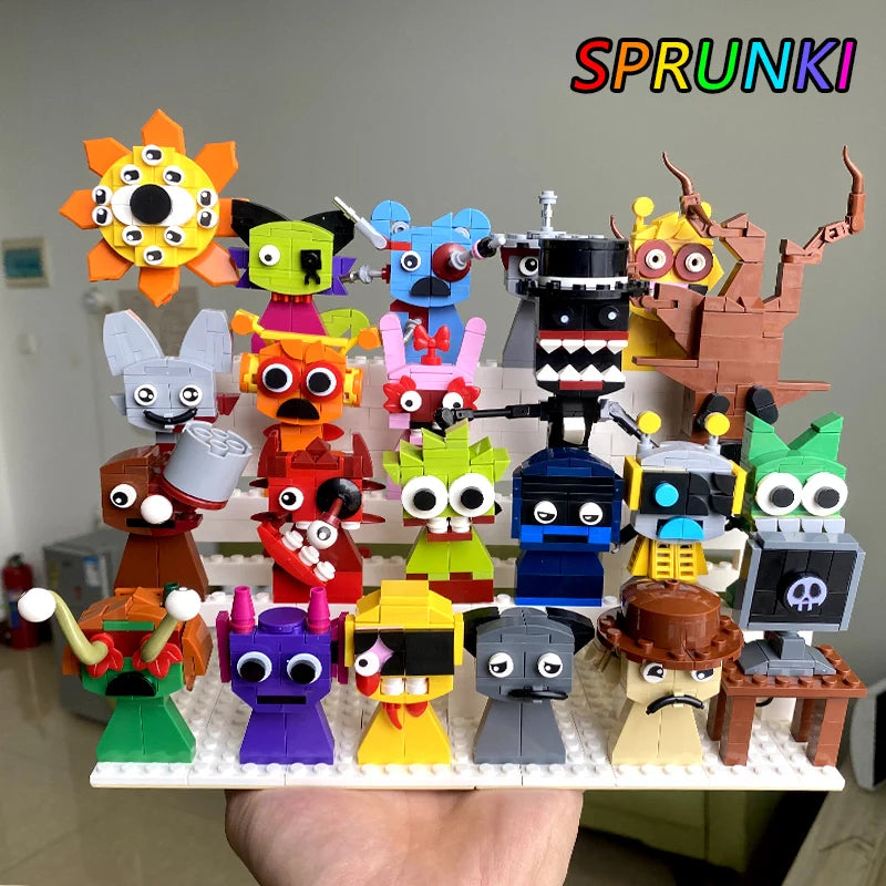 A hand presents the yellow New Moc Incredibox Sprunki Building Blocks Set, featuring 20 quirky LEGO monsters with googly eyes. SPRUNKI appears in rainbow letters at the top right. Ideal as a horror anime music game toy or gift for birthdays and Christmas.