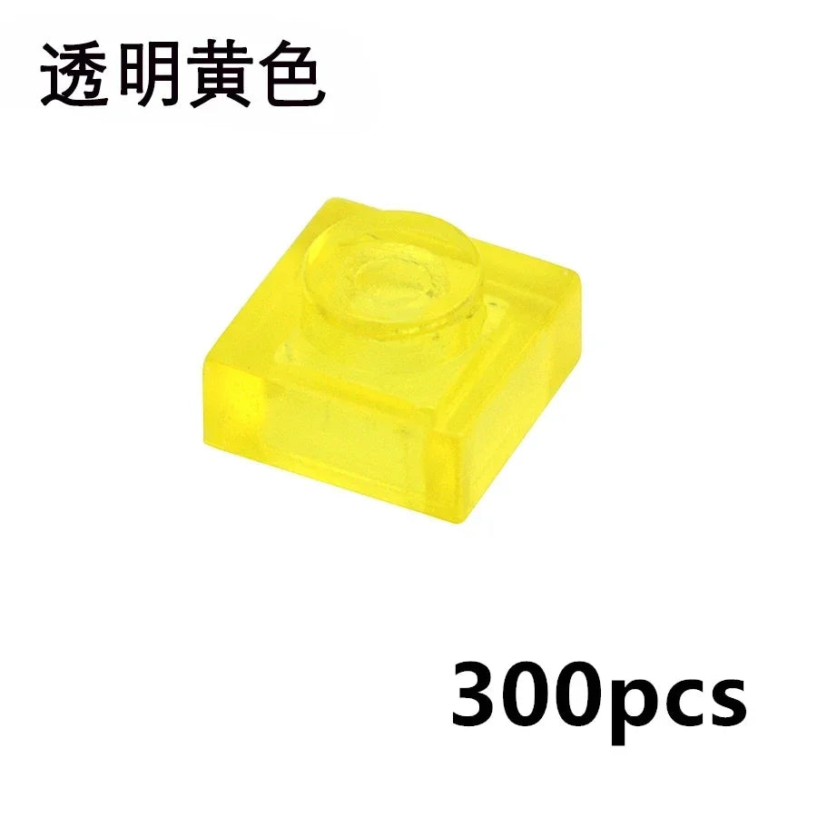 A transparent yellow MOC Bulk Brick from the Clear Building Block Set (1x1, 1x2, 1x4, 2x4) compatible with Lego is shown. Chinese text is above, 300pcs below—perfect for expanding your building block collection.