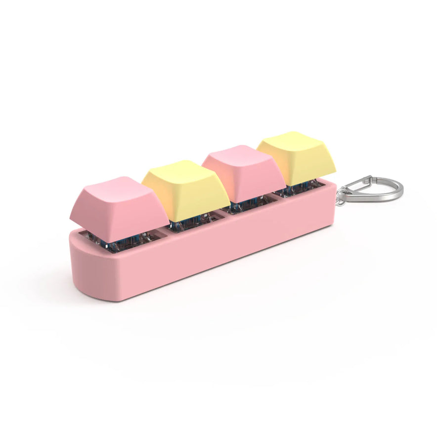 The 4Keys Finger Button Anti Stress Toy is a pink and yellow rectangular keychain with four mechanical keyboard keycaps in a row, providing stress relief on the go. It includes a metal ring for easy attachment—great for kids and adults alike.