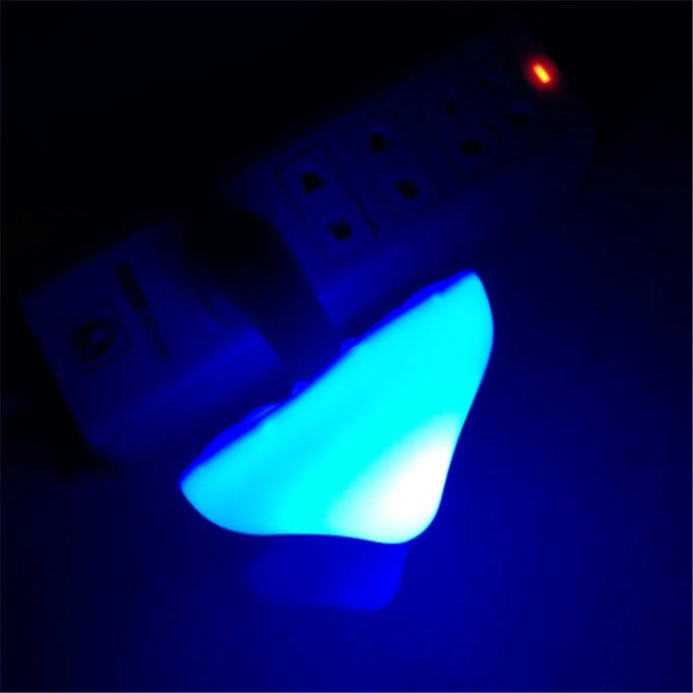The Mushroom LED Night Light with Sensor Control casts a warm glow, similar to a mushroom wall socket lamp. It features multiple outlets, an activation indicator light, and emits a subtle hue in mostly dark areas, enhanced by its sensor control.