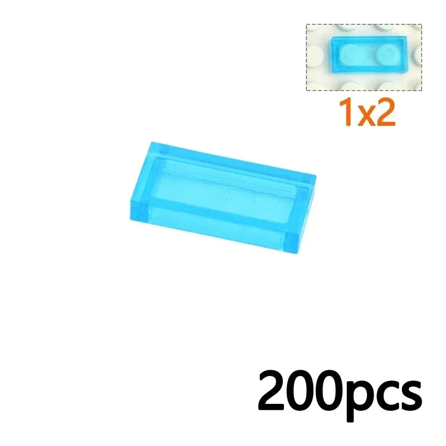 A 3069-Light Blue translucent 1x2 brick from the MOC Transparent Bulk Brick Set (compatible with Lego), shown with an inset of the same brick and 1x2 and 200pcs text—ideal for expanding your clear building block collection.