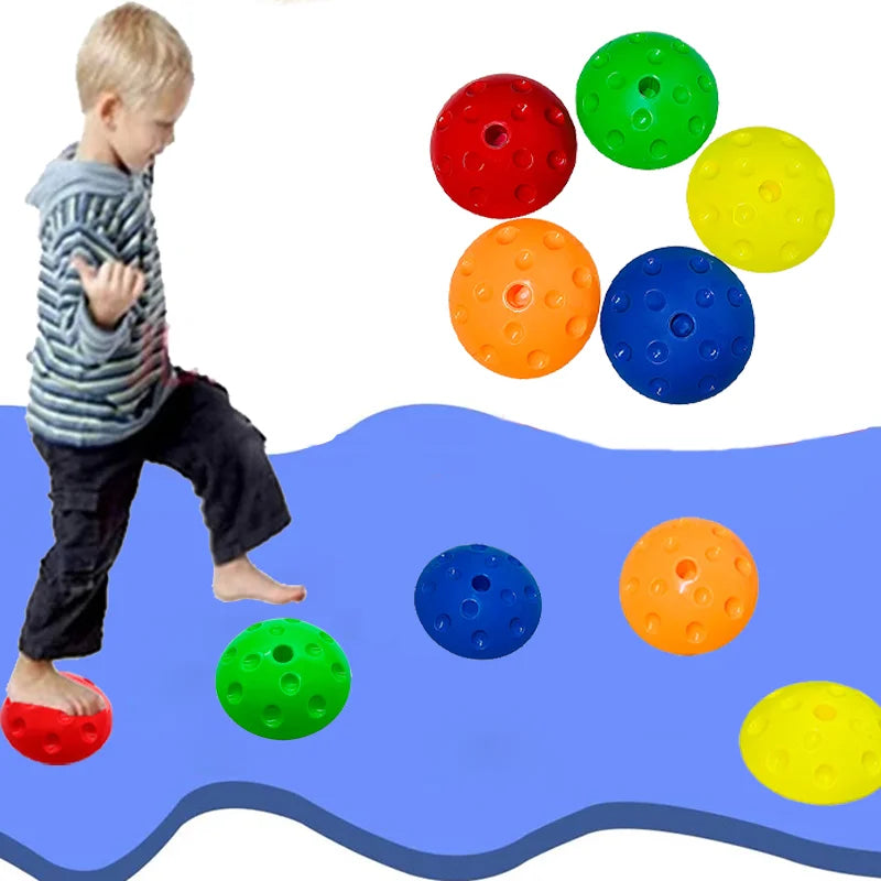 A child joyfully refines motor skills using Montessori-Inspired Kids Balance Stepping Stones for Sensory Play, stepping barefoot on a red stone over a blue wavy path. The stones have vibrant colors: red, green, blue, orange, and yellow with textured surfaces for sensory exploration.