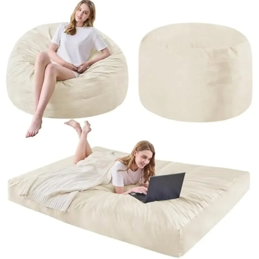 A woman sits on a large, Queen-Beige Bean Bag Chairs Convertible Bean Bag Bed with a microfiber cover and foam filler; she also lies on it when its converted into a bed, using her laptop.