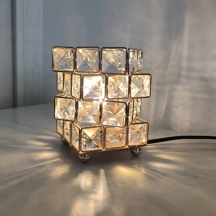 The Himalayan Salt Crystal LED Lamp is a decorative table lamp with a cube design featuring smaller crystal-like cubes. It emits a soft, warm glow for ambiance and shadow play, conveniently powered by USB.