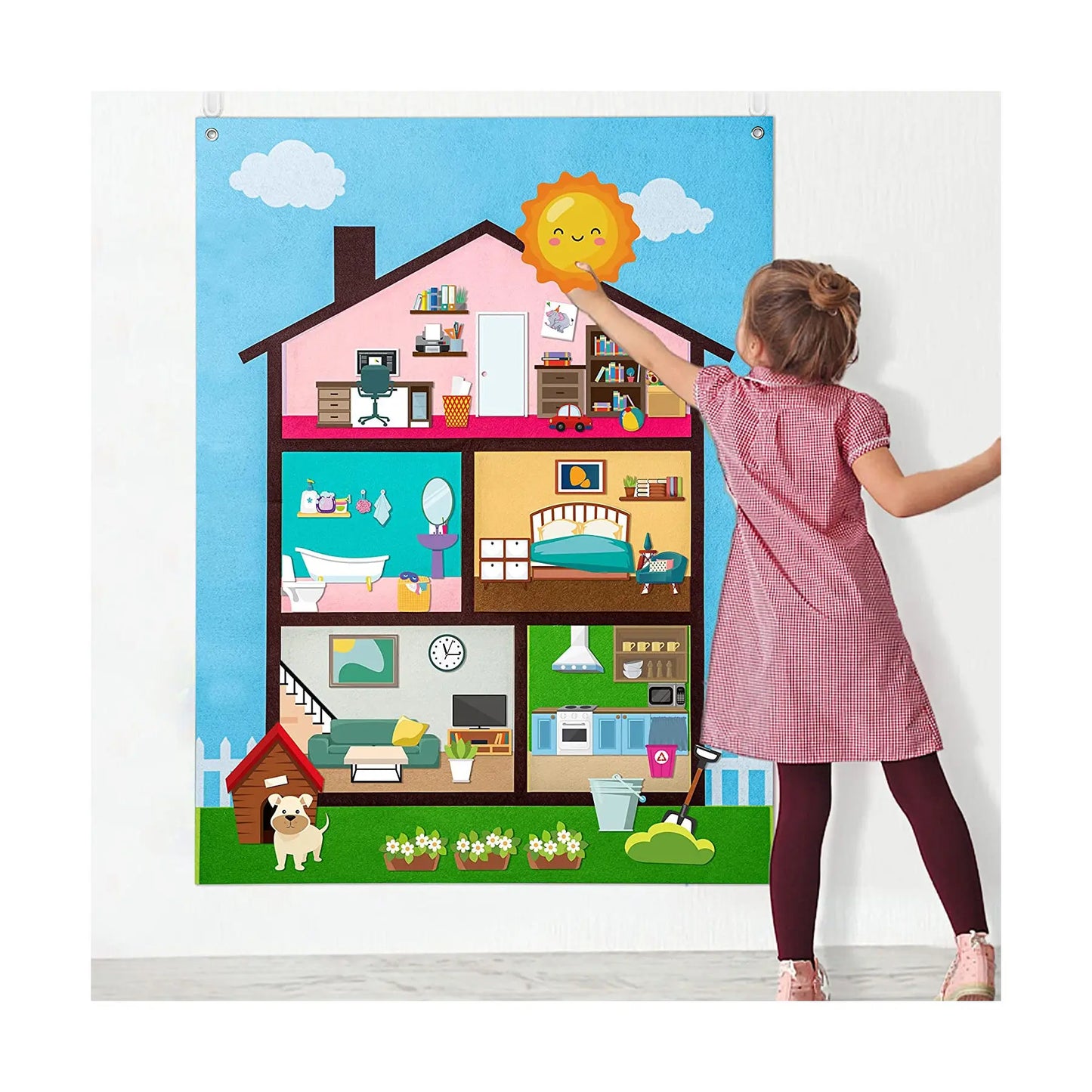 A young girl in a pink dress reaches up to place a sun cutout on the House-colored My Daily Calendar Farm Transportation Felt Story Board for Toddlers, a Montessori toy featuring rooms, furniture, pets, and an outdoor garden for educational storytelling.