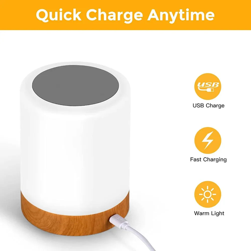 Image of a cylindrical portable table lamp with a wooden base, showcasing USB charge and fast charging icons. The top is gray with Quick Charge Anytime text, featuring the Portable Touch-Sensitive LED Night Light with RGB and warm white options for kids rooms and gifts.