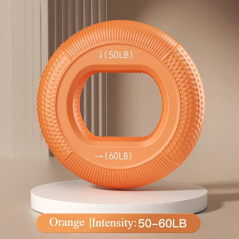 Orange Silicone Grip Trainer Ring for hand strengthening and wrist rehabilitation, designed to enhance grip. Features a textured surface and adjustable intensity levels of 50LB to 60LB. Displayed on a white platform with neutral-toned vertical lines in the background.