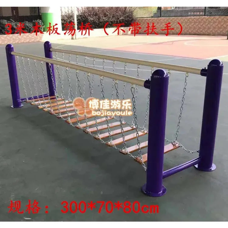 An indoor play structure resembling a suspension bridge features wooden and chain components with purple metal supports, evoking unisex childrens toys. The text displays specifications and a Chinese brand name, relating to outdoor toys, swings, climbing nets, and sports equipment for sensory integration.