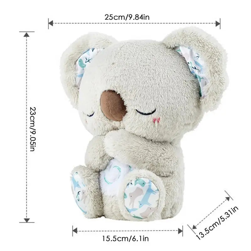 This Koala Night Light Plush Toy, a musical sensory sleep aid for newborns, features closed eyes, light gray fur, and patterned fabric on its ears and feet. It plays soothing melodies while offering comforting cuddles. Dimensions: height 23cm, length 25cm, width 13.5cm, depth 15.5cm.
