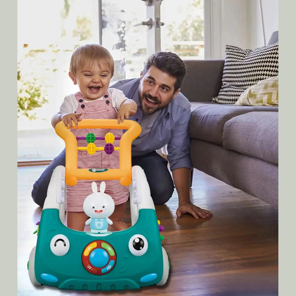 A smiling toddler pushes the EDUCIRO 4-in-1 Baby Walker while an adult kneels nearby on a wooden floor in a bright living room.